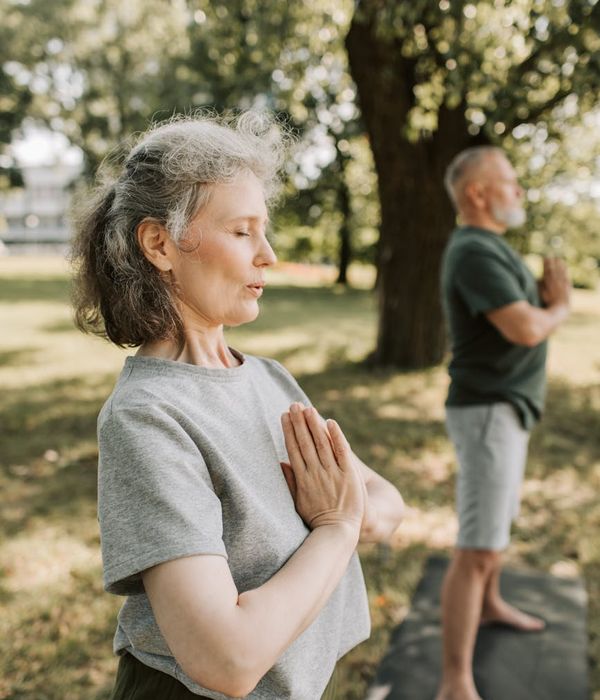 Person meditating peacefully in a natural, serene environment.